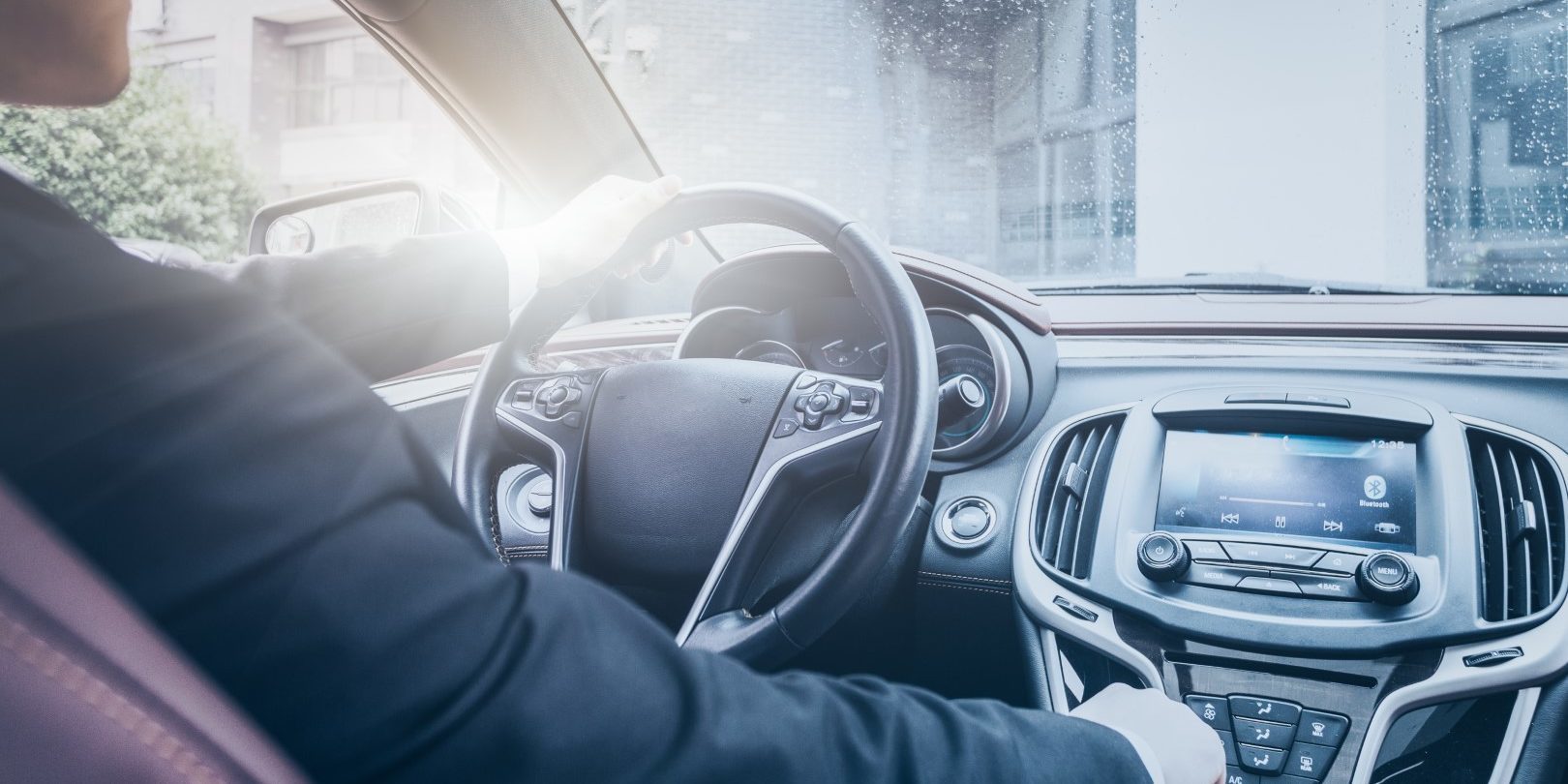 detail shot of young businessman driving his car.